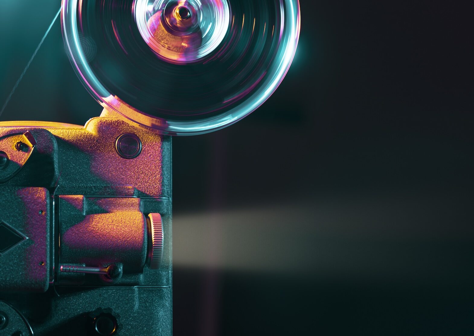 Vintage old fashioned projector in a dark room projecting a film, cinematography concept